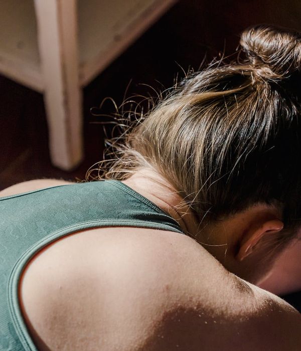 Woman practicing a breathing exercise in a serene morning setting.